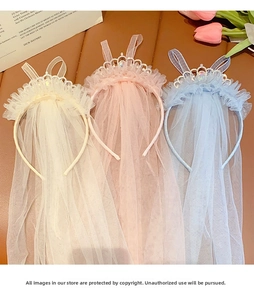 Detail of glittery crown headbands with long lace tulle veils in white, pink and blue
