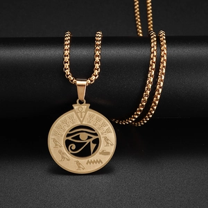 Detailed close-up of golden Eye of Horus pendant on chain with Egyptian symbols