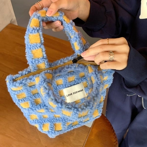 Detail of blue and yellow checkerboard plush tote bag with LOVE SOZAKKA woven label