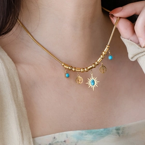Golden Tree of Life necklace with blue turquoise beads and sunburst star pendant charm