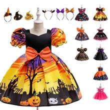 Detail of Halloween pumpkin princess dress for girls with orange bows and festive patterns