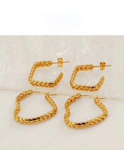 Detail view of gold earrings set featuring textured wheat grain heart and square designs