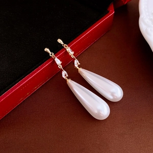 Detailed view of French vintage drop earrings with gold plating, zircon, and water drop pearls