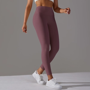 Detail of high-waist yoga leggings in dark rose purple featuring seamless hem and tummy control