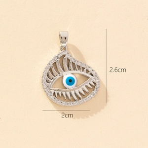 Detailed view of silver evil eye pendant with blue enamel and dimensions 2.6cm by 2cm
