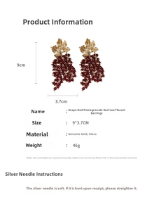 Detail view of gold leaf and red glass grape earrings showing 9x3.7cm size specs