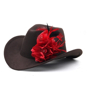 Close-up of red flower, mesh, and feather trim on dark brown wool western cowboy hat