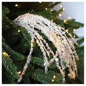 Sparkling white Christmas tree sequin tassel ornaments on branches with warm LED lights