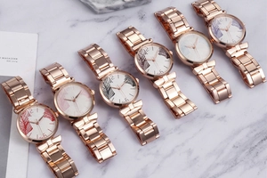 Detail shot of women's mesh band watches with diverse colorful tropical leaf dial patterns