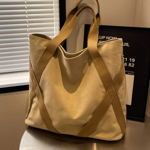 Large beige canvas tote bag with brown straps for stylish daily commute and shopping