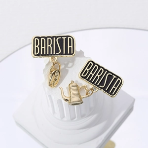 Detailed view of Barista theme earrings featuring golden coffee beans and pots
