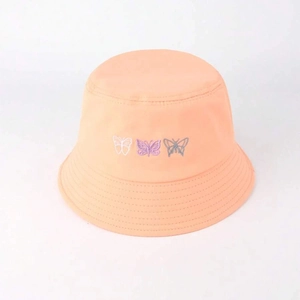 Fashionable peach bucket hat with colorful butterfly embroidery for summer sun protection