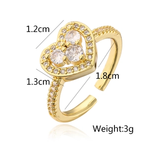 Macro detail of gold-plated heart ring with zircon inlay and product dimensions