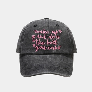 Detail of pink embroidered text wake up and do the best you can on washed canvas cap