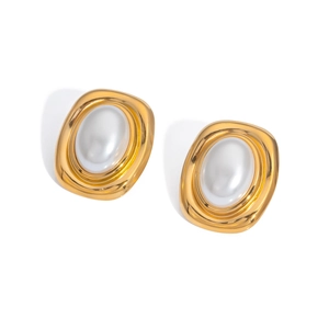 Close-up of vintage French style gold earrings with inlaid white oval pearls