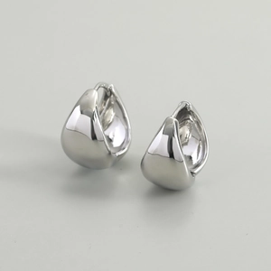 Detailed view of polished silver water drop earrings with smooth metallic finish