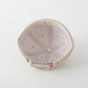 Detail of beige corduroy docker hat showing inner seams and adjustable velcro strap