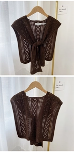 Detail of dark brown hollow knit shawl featuring V-shape texture and front tie design