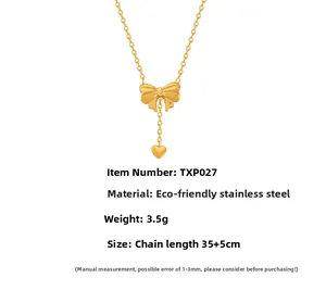 Detail view of gold bow necklace with heart pendant, stainless steel, 35+5cm length