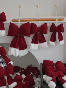 Detail of red velvet Christmas bows with faux fur trim in various sizes for holiday decor