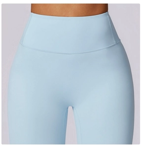 Detail of high waisted compression waistband on light blue athletic yoga leggings