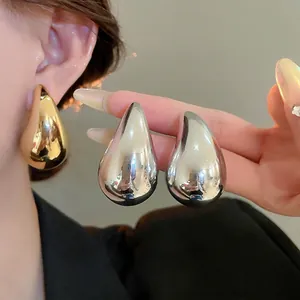 Fashionable oversized teardrop acrylic earrings in polished gold and silver finishes