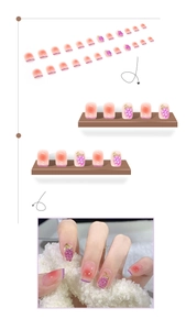 Detailed close-up of purple gradient press-on nails with 3D grape charms and gold leaves