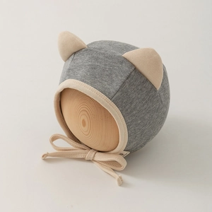 Detail of grey newborn hat with cat ears and ribbed cotton fabric for babies