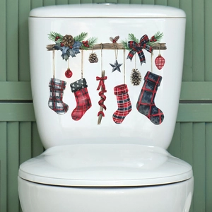 Christmas stocking decals with buffalo plaid patterns applied to a white toilet tank