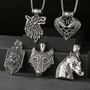 Detail view of retro Viking pendants featuring wolf, lion and horse in steel