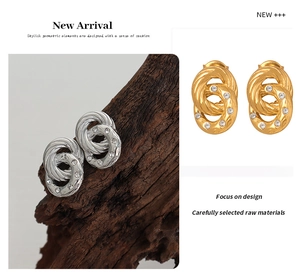 Detail of twisted double hoop earrings with sparkling rhinestones in gold and silver