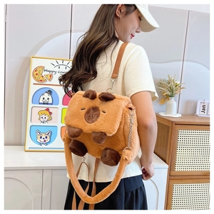 Side view of cute brown plush Capybara backpack on a model in a warm indoor setting