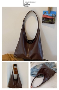 Detail of coffee brown leather tote bag showing integrated shoulder strap and large capacity