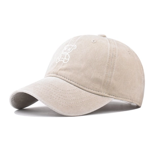 Detail of washed cotton texture and white bear embroidery on khaki baseball cap