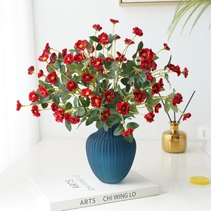 Artificial red roses in a blue ceramic vase for elegant home decor and photography