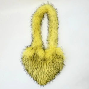 Detailed close-up of heart-shaped faux fur handbag in vibrant yellow and black tones