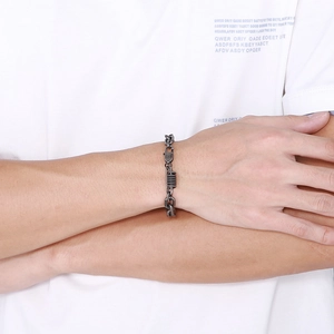 Detail shot of a dark grey stainless steel O-chain bracelet with spring elements on wrist