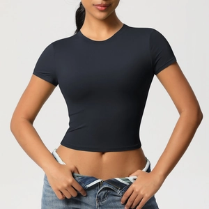 Detail of black slim fit crop top showing the crew neck and smooth athletic fabric texture