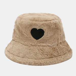 Detail of khaki plush bucket hat with black heart patch and gold embroidery