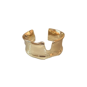 Minimalist wide open gold cuff bracelet with irregular wavy texture and polished finish