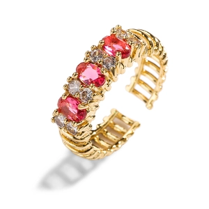 18K gold plated open ring featuring red oval zircons and hollow geometric pattern