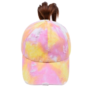 Detail of tie-dye ponytail baseball cap with distressed finish and crossed back opening