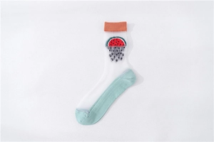 Detail of sheer crystal socks with sweet watermelon pattern and vibrant orange ribbed cuffs