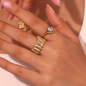Close-up of 18K gold plated rings with micro-pave white zircon inlay on model's hand