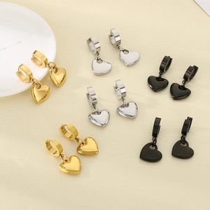 Three pairs of hollow heart dangle earrings in gold, silver, and black polished steel
