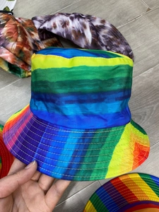 Detailed close-up of rainbow striped reversible bucket hat showing colorful fabric texture
