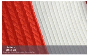 Detail of red cable-knit and white ribbed-knit splicing on warm men's sweater