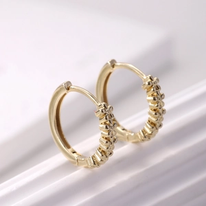 Gold minimalist hoop earrings with textured floral bead detailing for daily wear