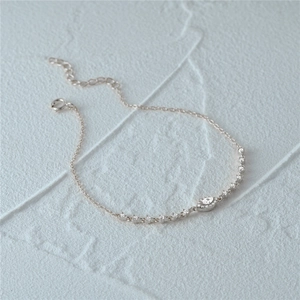Macro shot of silver bracelet with marquise-cut stone and adjustable lobster clasp
