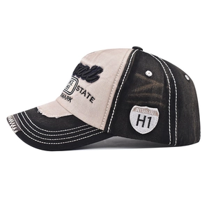 Close-up of vintage washed baseball cap featuring Hawaii embroidery and distressed brim